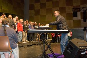 Ken rehearsing the choir - by Brian Rope